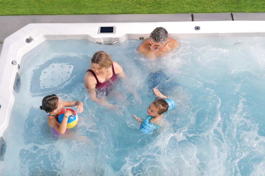A family enjoying their new hot tub provided by Steiners Hot Tubs.